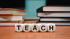 Buchstabenbauklötze bilden das Wort "Teach".