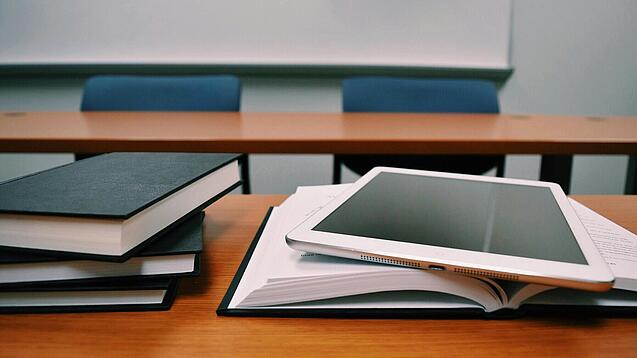 Tablet und Bücher auf einem Pult.