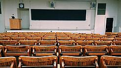 Ein leerer Hörsaal mit Bänken für die Studierenden.